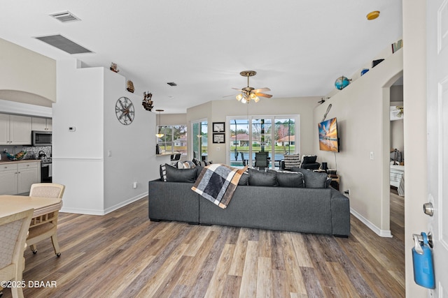 living room featuring hardwood / wood-style flooring and ceiling fan