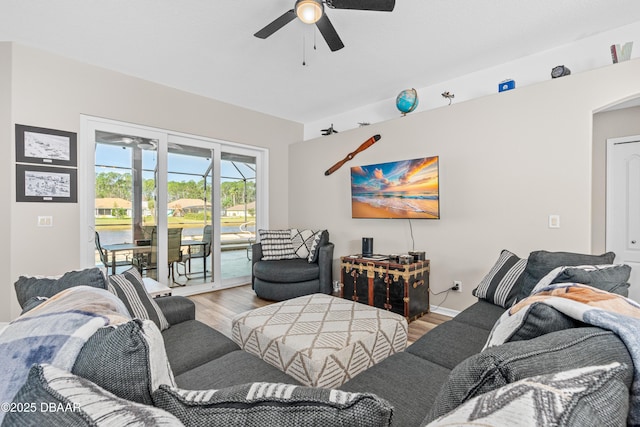 living area featuring a ceiling fan and wood finished floors