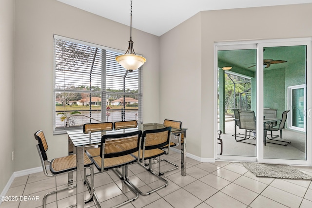 dining space with baseboards and light tile patterned flooring