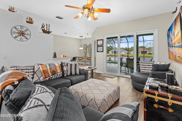 living room featuring ceiling fan and light hardwood / wood-style floors