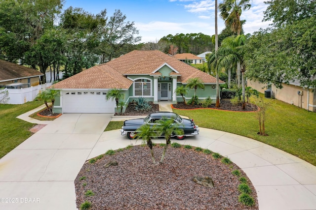 mediterranean / spanish home with a garage and a front lawn