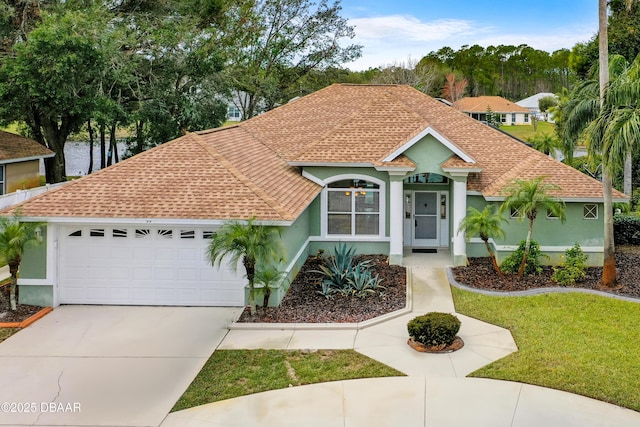 view of front facade with a garage and a front yard