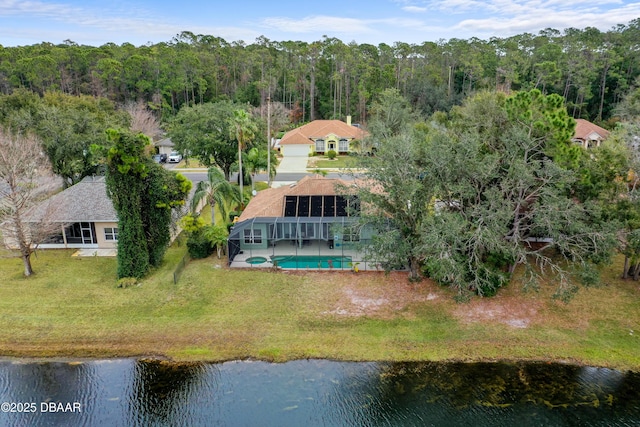 bird's eye view with a water view and a wooded view