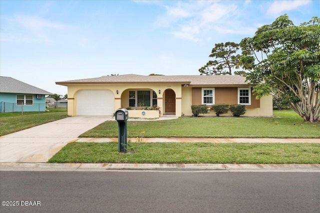 single story home with a garage, concrete driveway, a front lawn, and stucco siding