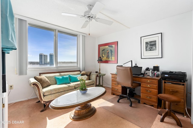 carpeted home office with ceiling fan