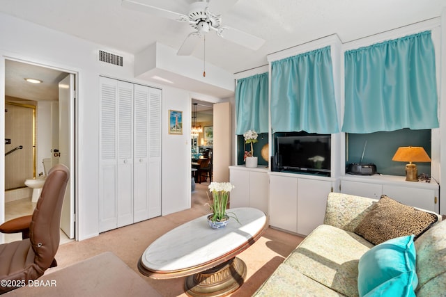 living room with ceiling fan and light colored carpet