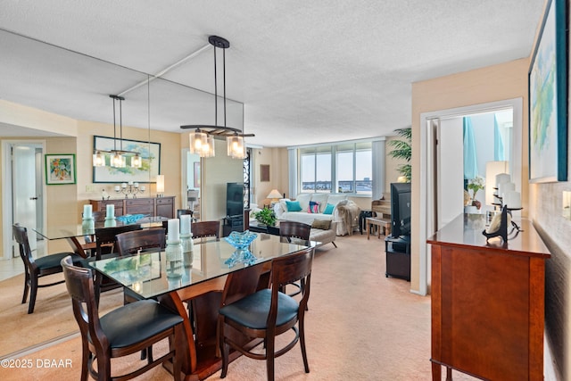 carpeted dining space with a textured ceiling