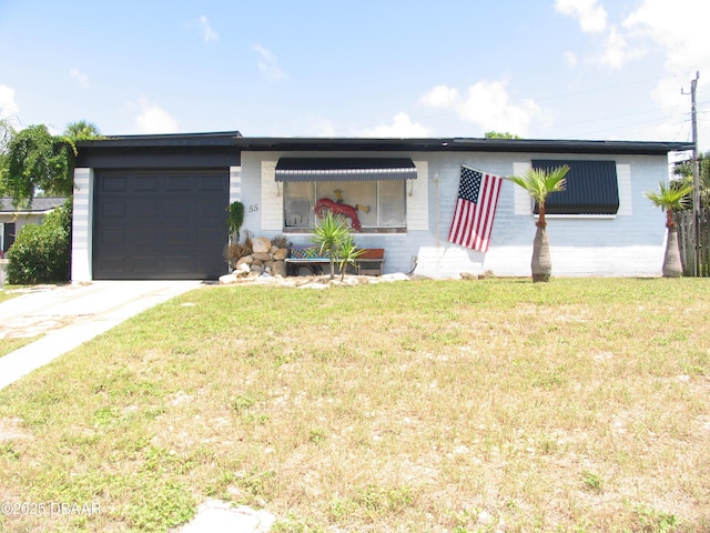 55 Seaside Dr, Ormond Beach, FL 32176 - view of front of home with a garage, concrete driveway, a front yard, and brick siding