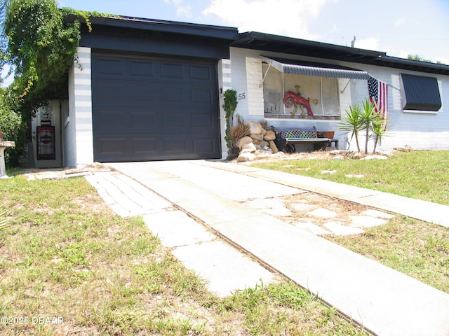 55 Seaside Dr, Ormond Beach, FL 32176 - ranch-style house featuring driveway, a garage, and a front yard