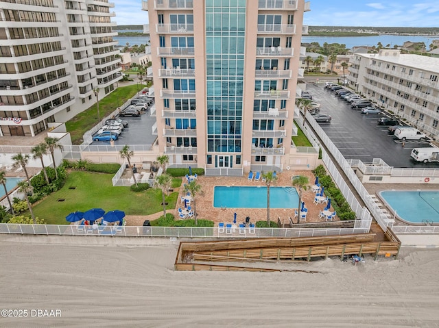 3737 S Atlantic Ave Unit 702, Daytona Beach, FL 32118 - drone / aerial view of a pool and a nearby body of water