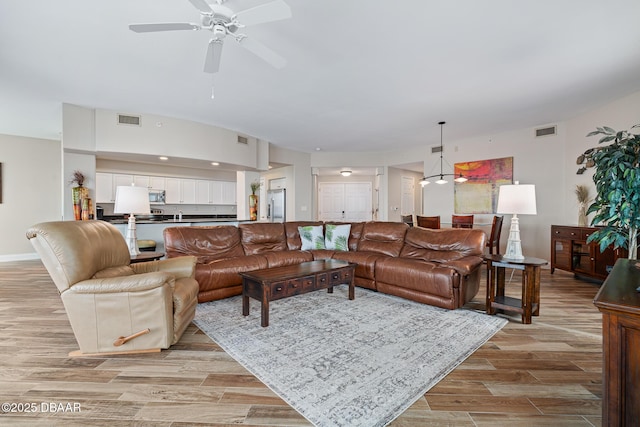 3737 S Atlantic Ave Unit 702, Daytona Beach, FL 32118 - living area featuring light wood-style flooring and ceiling fan