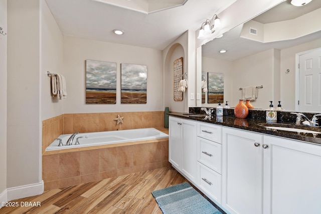 3737 S Atlantic Ave Unit 702, Daytona Beach, FL 32118 - full bath with wood finished floors, double vanity, and a garden tub