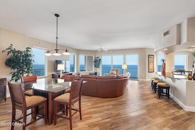 3737 S Atlantic Ave Unit 702, Daytona Beach, FL 32118 - dining area featuring light wood-type flooring and ceiling fan