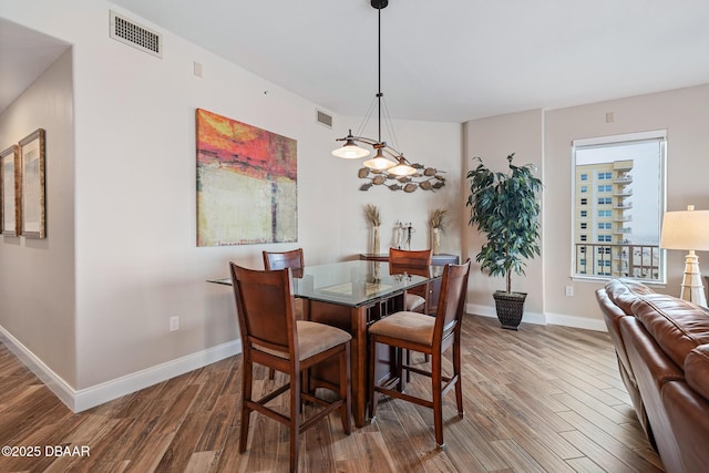 3737 S Atlantic Ave Unit 702, Daytona Beach, FL 32118 - dining room featuring wood finished floors and baseboards