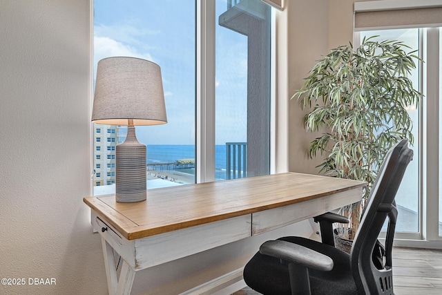 3737 S Atlantic Ave Unit 702, Daytona Beach, FL 32118 - office area featuring a water view, a textured wall, and wood finished floors