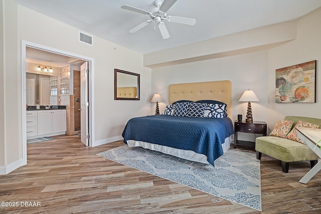 3737 S Atlantic Ave Unit 702, Daytona Beach, FL 32118 - bedroom with wood finished floors, connected bathroom, and ceiling fan