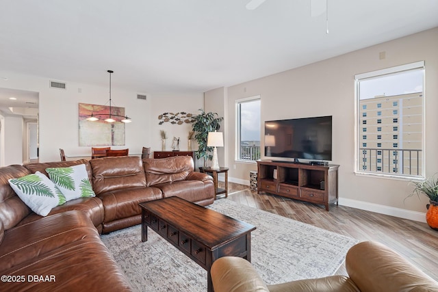3737 S Atlantic Ave Unit 702, Daytona Beach, FL 32118 - living area featuring ceiling fan and wood finished floors