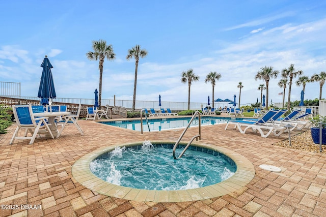 3737 S Atlantic Ave Unit 702, Daytona Beach, FL 32118 - community pool with a patio and a hot tub
