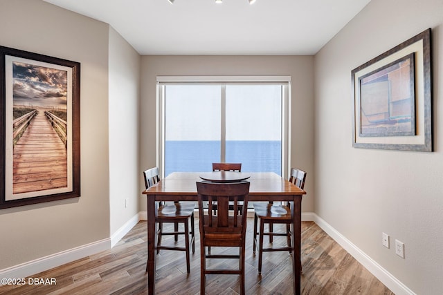 3737 S Atlantic Ave Unit 702, Daytona Beach, FL 32118 - dining space with light wood-type flooring and baseboards