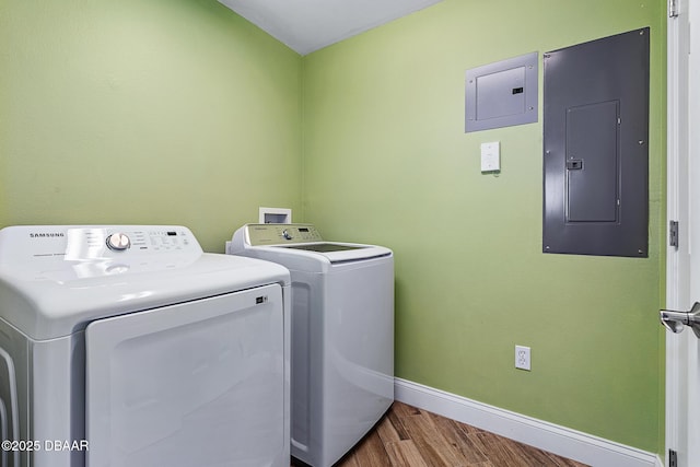 3737 S Atlantic Ave Unit 702, Daytona Beach, FL 32118 - laundry area with electric panel, washer and clothes dryer, and wood finished floors