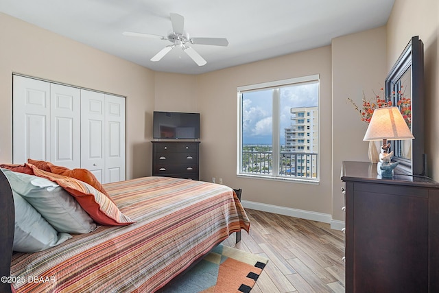3737 S Atlantic Ave Unit 702, Daytona Beach, FL 32118 - bedroom featuring a closet, light wood-type flooring, and ceiling fan