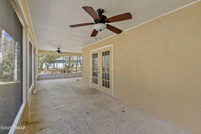 unfurnished sunroom featuring french doors and ceiling fan