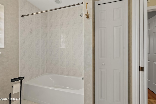 bathroom featuring bathing tub / shower combination and a closet