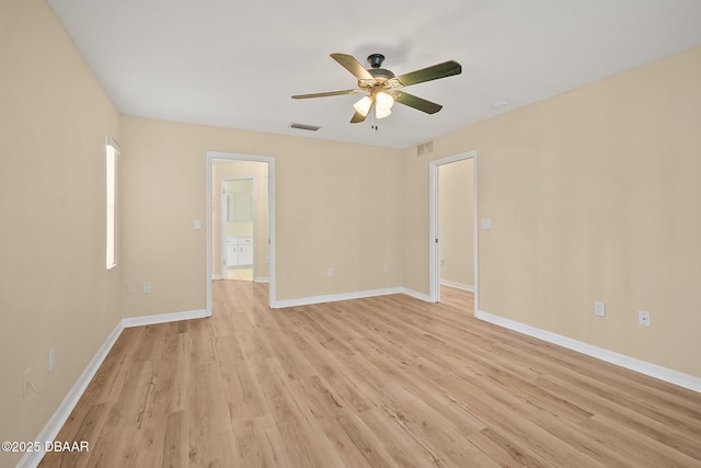 unfurnished room featuring visible vents, baseboards, light wood-style flooring, and a ceiling fan