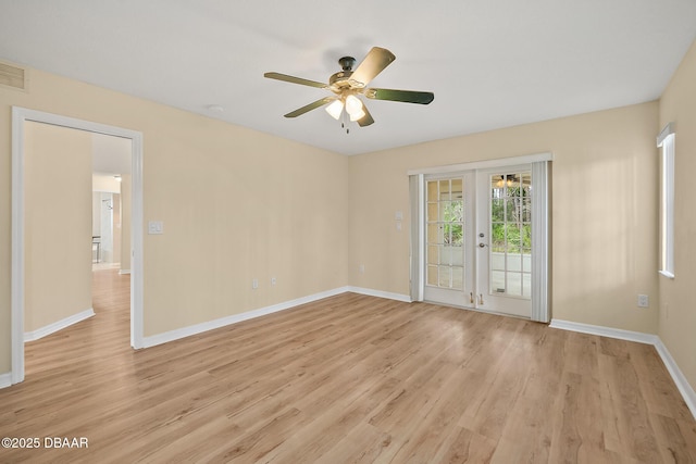 empty room with light wood-type flooring, baseboards, ceiling fan, and french doors