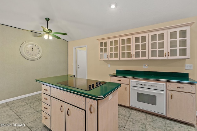 kitchen featuring white oven, black electric cooktop, dark countertops, and ceiling fan