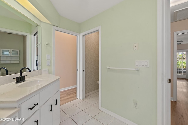 bathroom featuring tile patterned floors, baseboards, and vanity