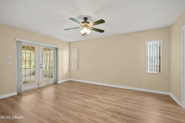 unfurnished room featuring a ceiling fan, french doors, light wood-type flooring, and a wealth of natural light