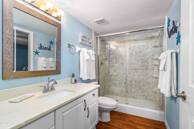 3333 S Atlantic Ave Unit 1802, Daytona Beach, FL 32118 - bathroom featuring vanity, wood finished floors, and a shower stall