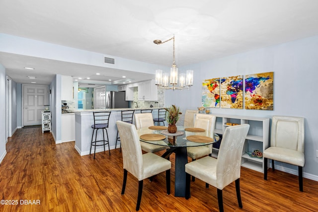 3333 S Atlantic Ave Unit 1802, Daytona Beach, FL 32118 - dining area with a chandelier, dark wood-style floors, and recessed lighting