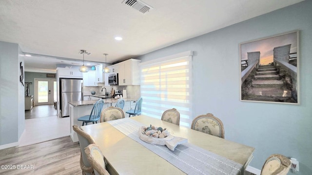 8 Tarpon Ave, Ormond Beach, FL 32176 - dining area featuring light wood-style floors, baseboards, and recessed lighting
