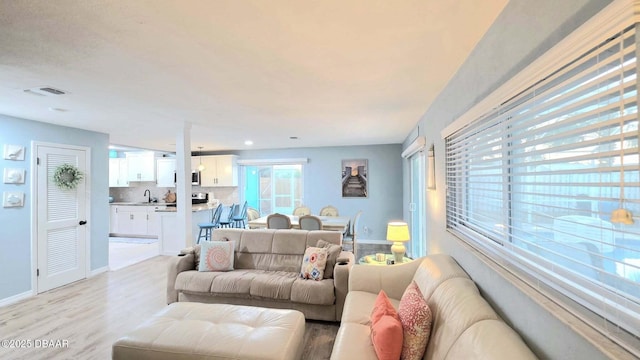 8 Tarpon Ave, Ormond Beach, FL 32176 - living room featuring light wood-type flooring and baseboards