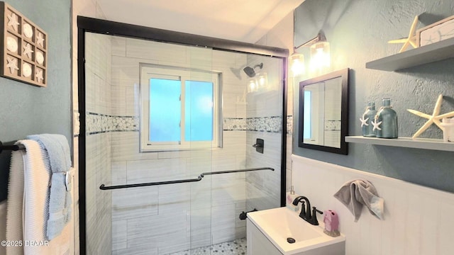 8 Tarpon Ave, Ormond Beach, FL 32176 - bathroom featuring a shower stall, wainscoting, vanity, and a textured wall