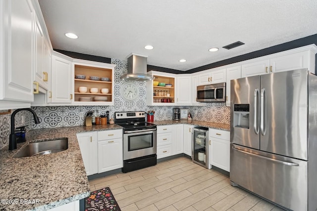 kitchen with appliances with stainless steel finishes, open shelves, a sink, wine cooler, and wall chimney range hood