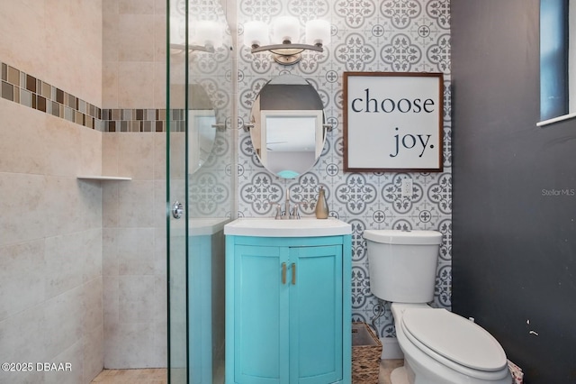 full bath with vanity, toilet, and tiled shower
