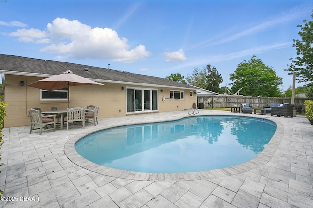 view of swimming pool with an outdoor living space, a patio, and fence