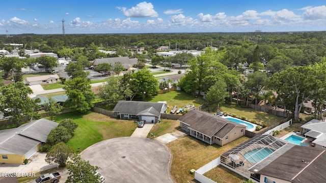 aerial perspective of suburban area featuring a pool