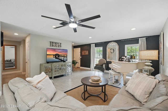 living room with recessed lighting, a ceiling fan, and baseboards