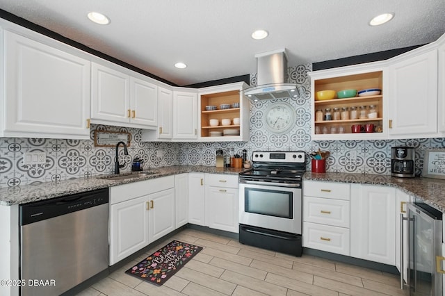 kitchen with appliances with stainless steel finishes, open shelves, a sink, extractor fan, and beverage cooler