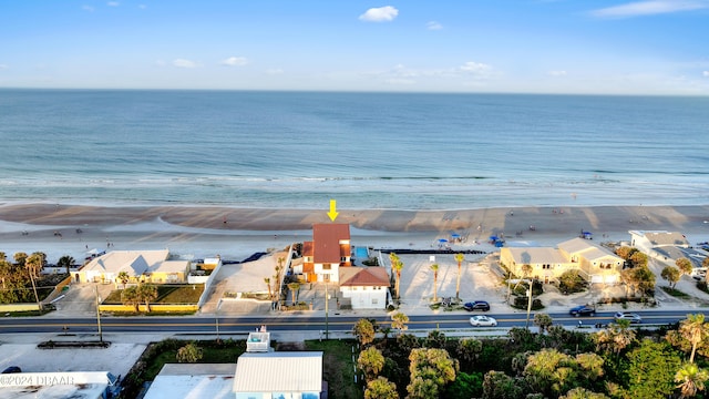 birds eye view of property featuring a water view and a beach view