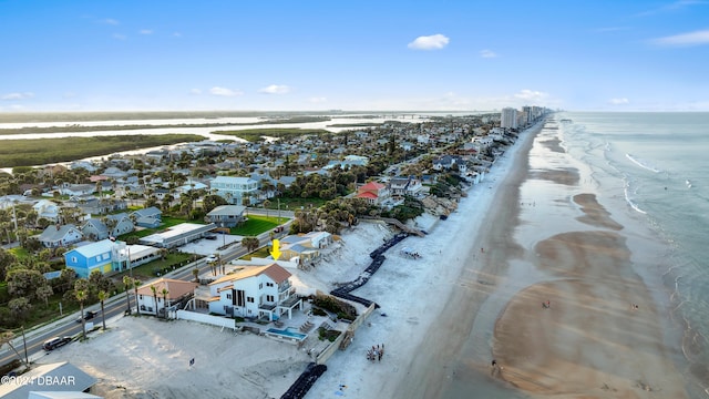 drone / aerial view featuring a water view and a view of the beach