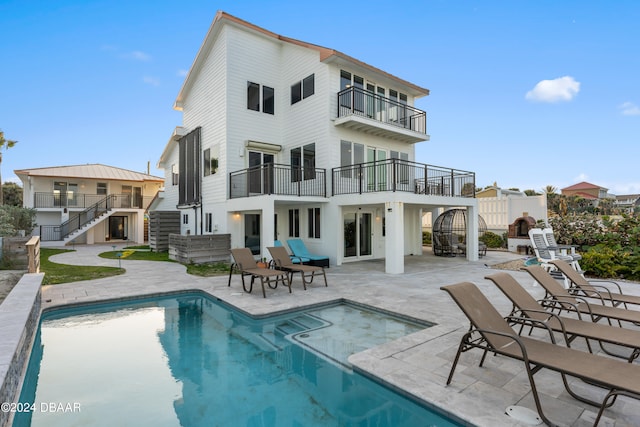 back of property with a balcony and a patio area