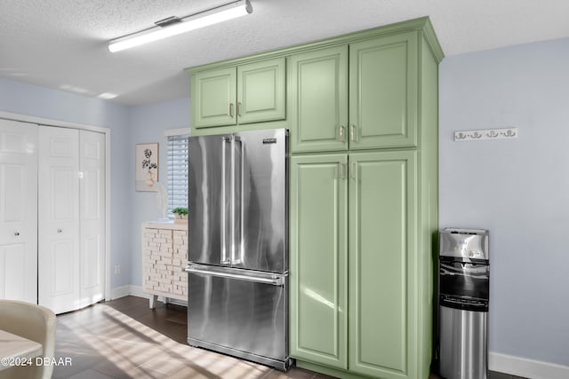 kitchen featuring a textured ceiling and high end refrigerator