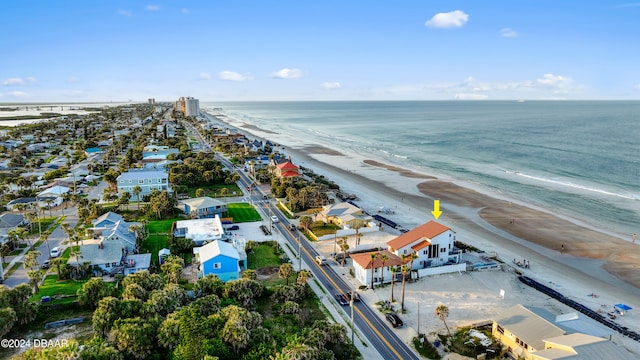 drone / aerial view with a beach view and a water view