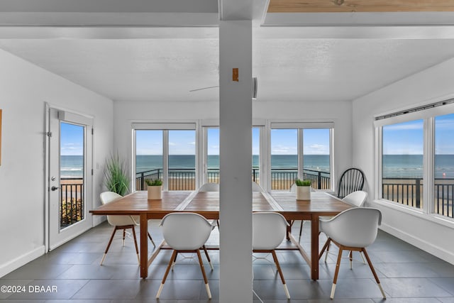 sunroom / solarium with a water view and plenty of natural light