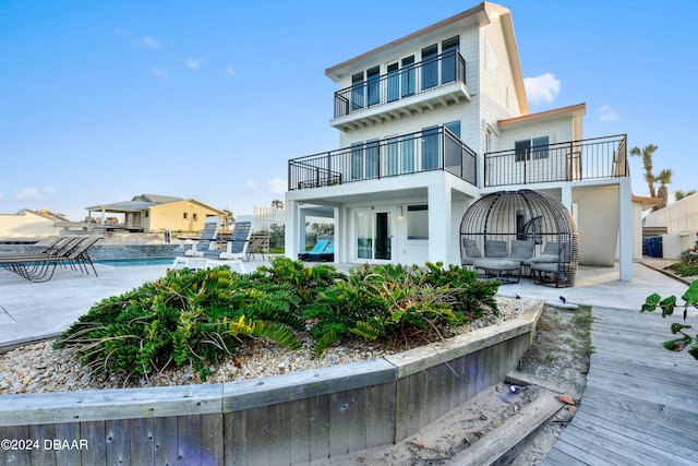 back of house featuring a patio area and a balcony